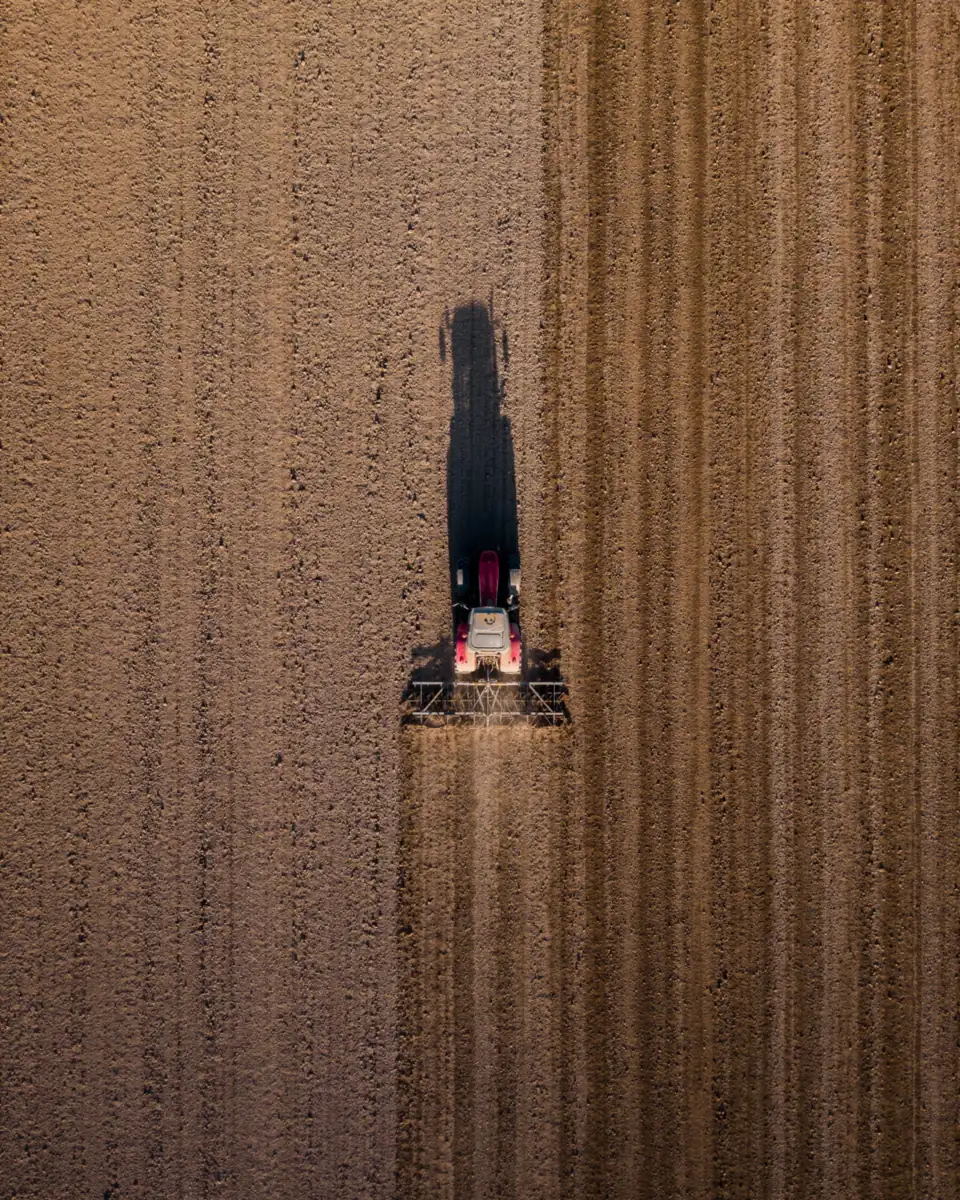 Vue aérienne de machines agricoles au travail dans un champ
